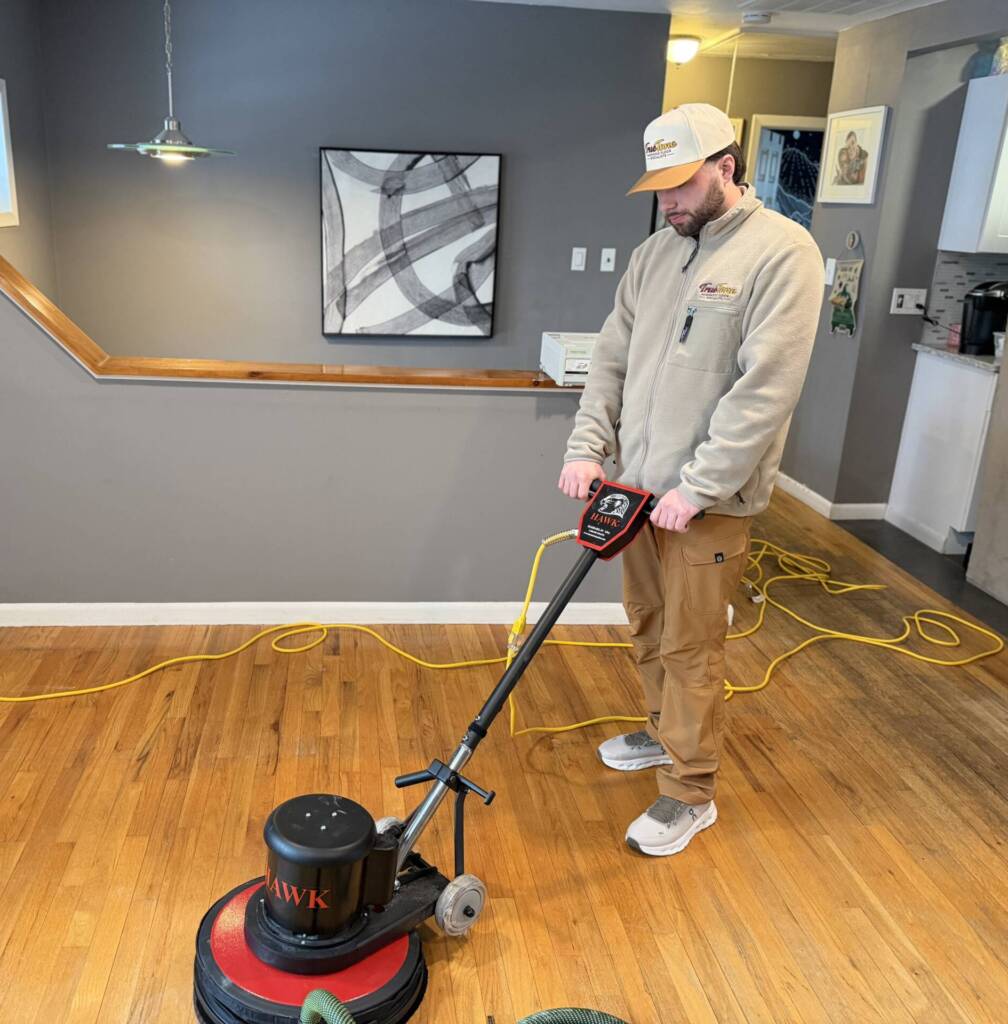 True Tone Hardwood owner operating a Hawk floor machine during screen and recoat service in New Jersey
